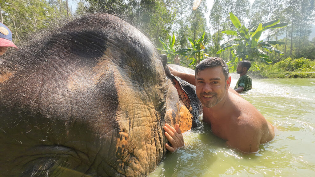 topless-man-with-elephant-in-Thailand